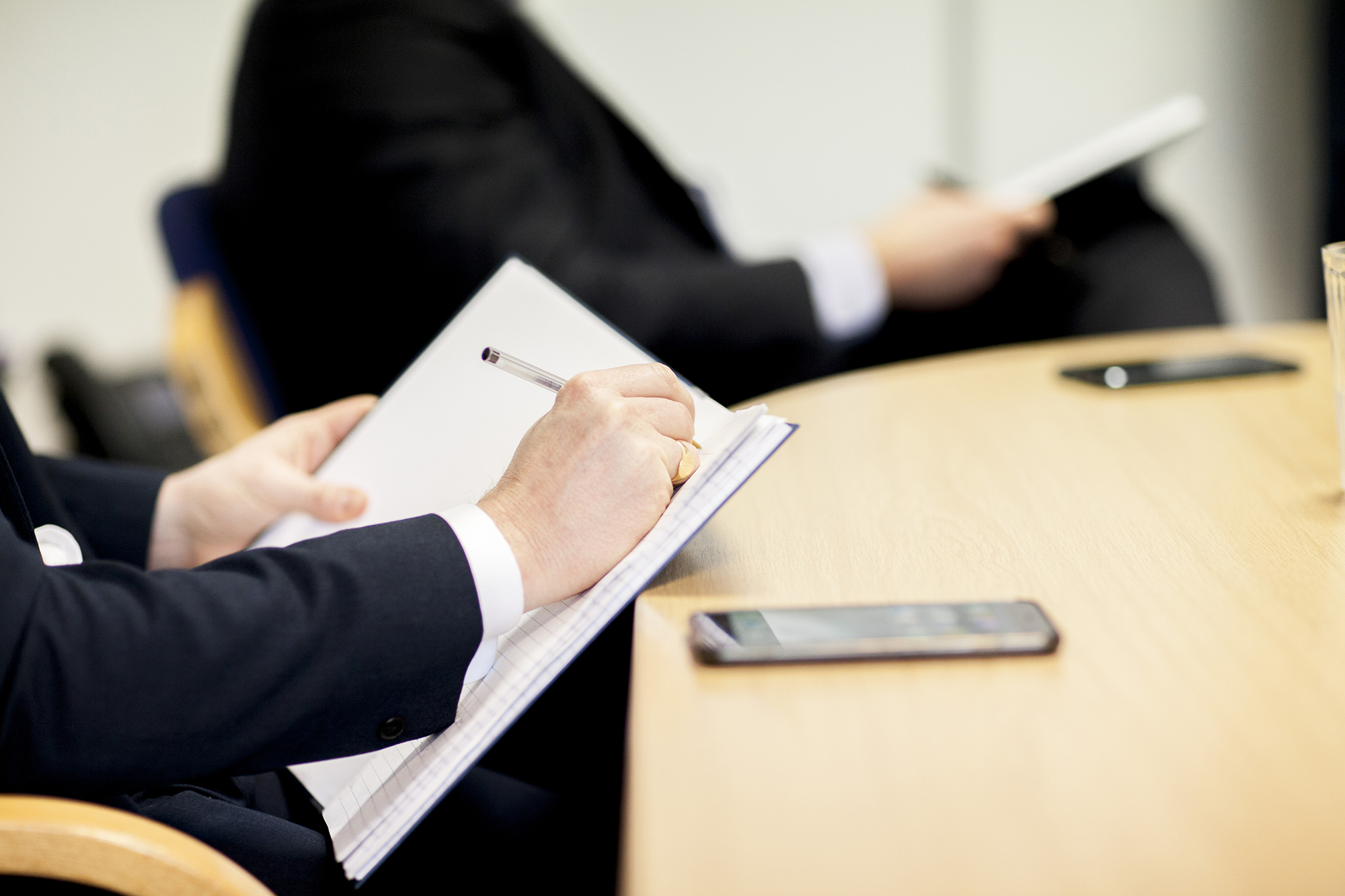 A graphic image of a person writing in a notepad, Aaron Wallis Sales Recruitment